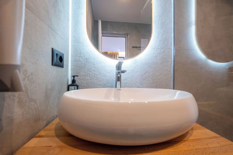 Shower, hair dryer, slippers, towels