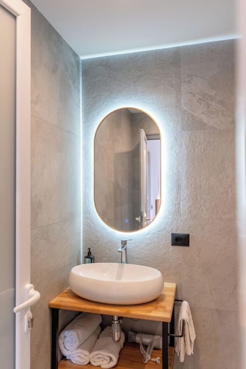 Shower, hair dryer, slippers, towels