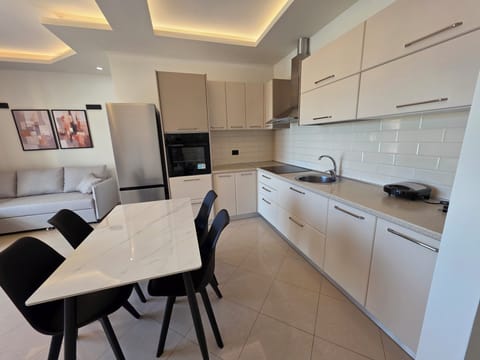 Family Apartment, Partial Sea View | Private kitchen | Oven, stovetop, dishwasher, cookware/dishes/utensils