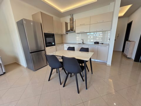 Family Apartment, Partial Sea View | Private kitchen | Oven, stovetop, dishwasher, cookware/dishes/utensils