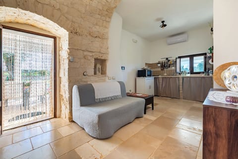Family Villa, Multiple Bedrooms (Trullo ConoSolo With Pool) | Living area | 21-inch Smart TV with digital channels, fireplace