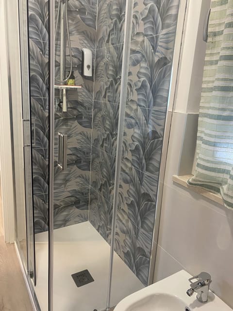 Deluxe Apartment, Patio | Bathroom | Shower, towels, soap, shampoo