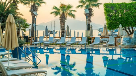 Outdoor pool, open 8:00 AM to 7:00 PM, pool umbrellas, sun loungers