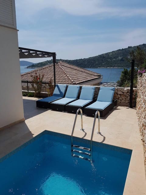 Outdoor pool, a heated pool, open open 24 hours, pool umbrellas