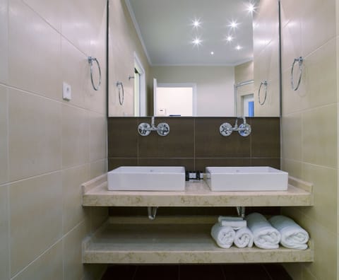 Shower, designer toiletries, hair dryer, bathrobes