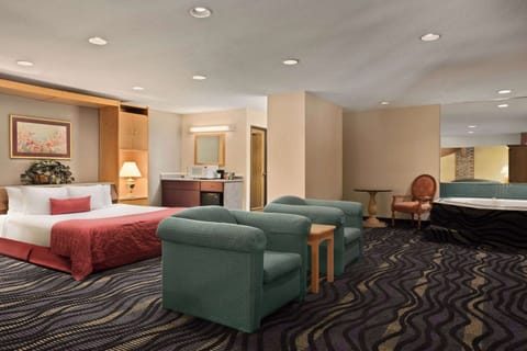 Suite, 1 King Bed, Non Smoking, Jetted Tub | In-room safe, blackout drapes, iron/ironing board, free rollaway beds