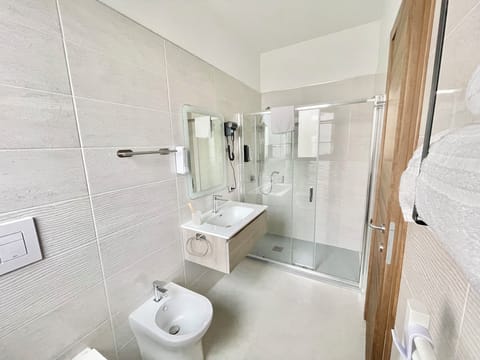 Shower, hair dryer, slippers, towels