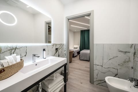 Family Triple Room, Balcony, Courtyard View | Bathroom | Shower, rainfall showerhead, free toiletries, hair dryer