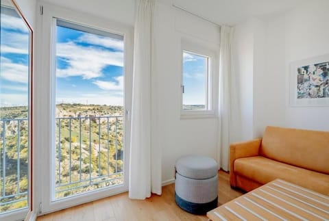 Deluxe Triple Room, City View | Living area | Flat-screen TV