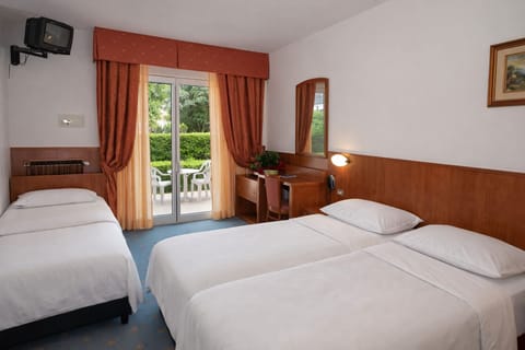 Family Triple Room, Garden View | In-room safe, desk, blackout drapes, free WiFi