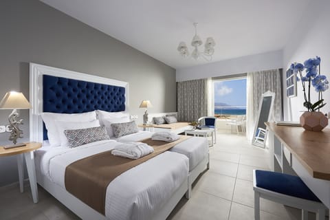 Deluxe Double Room, Partial Sea View | Minibar, in-room safe, iron/ironing board, free cribs/infant beds