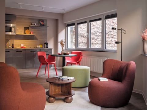 Deluxe Suite, 1 King Bed | Living area | 30-inch flat-screen TV with cable channels