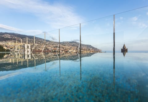 Indoor pool, outdoor pool, open 10:00 AM to 7:00 PM, pool umbrellas