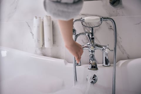 Deep soaking tub, designer toiletries, hair dryer, bathrobes