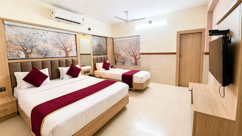 Deluxe Triple Room, City View | Desk, laptop workspace, free WiFi