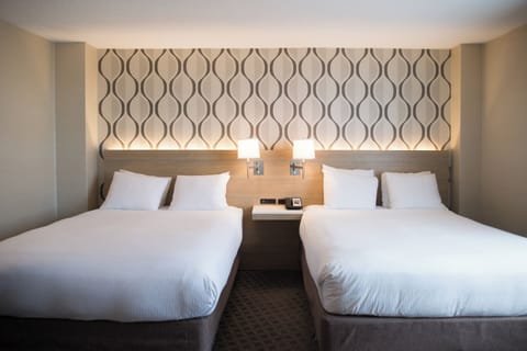 Premium bedding, desk, laptop workspace, blackout drapes