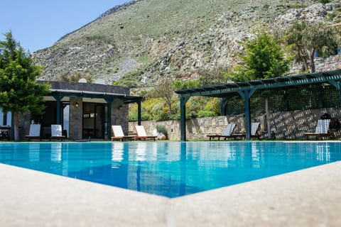 Seasonal outdoor pool, an infinity pool, pool umbrellas, sun loungers