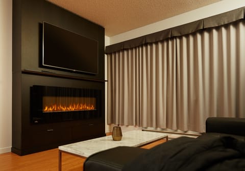 Deluxe Suite, 1 King Bed | Living area | 55-inch flat-screen TV with cable channels, TV, computer monitors