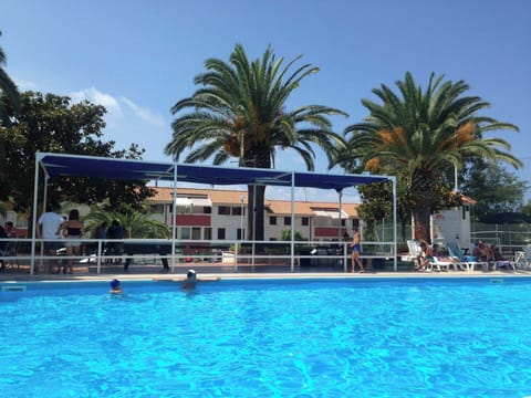 Seasonal outdoor pool, open 10:00 AM to 8:00 PM, pool umbrellas