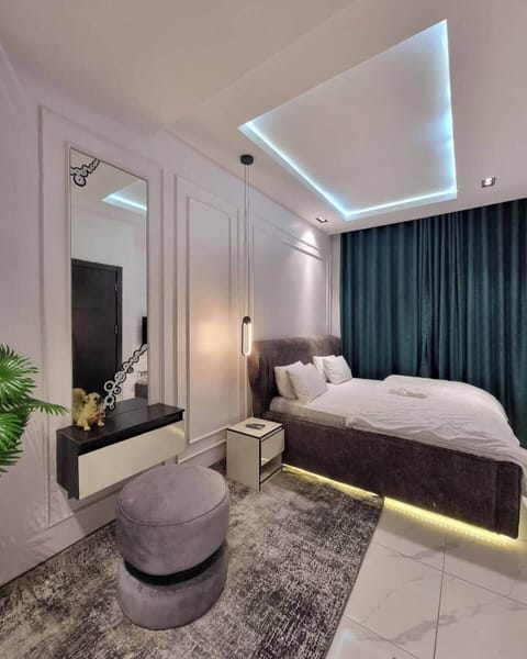 Deluxe Apartment, Balcony, City View | In-room safe, desk, laptop workspace, blackout drapes