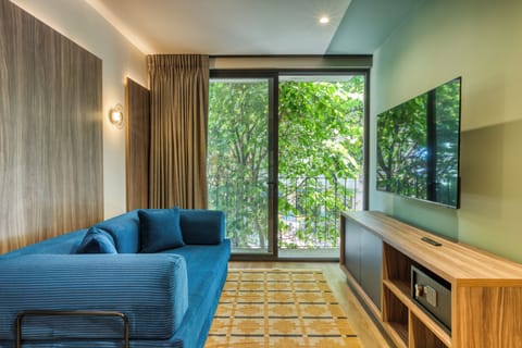 Deluxe Apartment, 1 King Bed with Sofa bed, City View | Living area | 55-inch Smart TV with digital channels