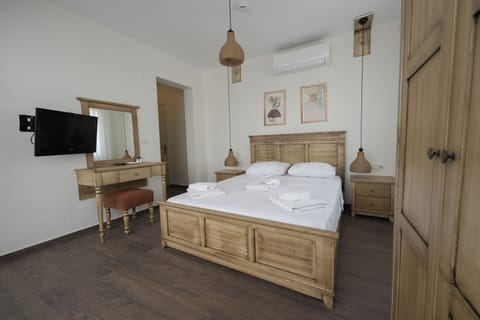 Superior Triple Room, Garden View | Minibar, desk, laptop workspace, free WiFi