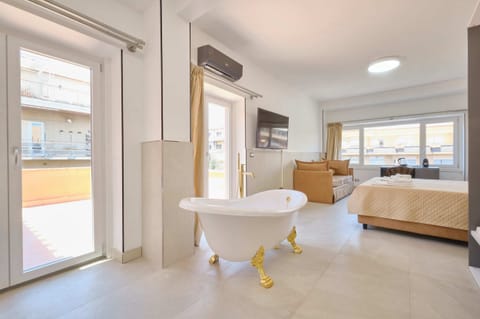 Deluxe Triple Room, City View | In-room safe, laptop workspace, blackout drapes, soundproofing