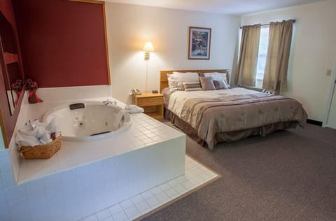 Room, 1 King Bed, Jetted Tub | Blackout drapes, iron/ironing board, free WiFi, bed sheets