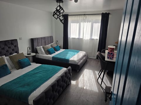Deluxe Double or Twin Room | Desk, laptop workspace, blackout drapes, iron/ironing board
