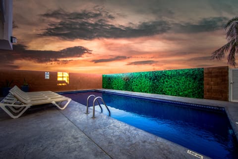 Outdoor pool, open 9:00 AM to 9:00 PM, pool umbrellas, sun loungers
