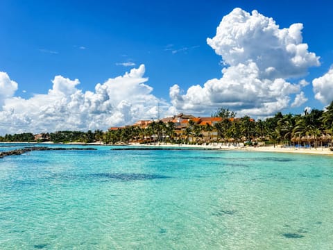 On the beach, white sand, sun loungers, beach umbrellas