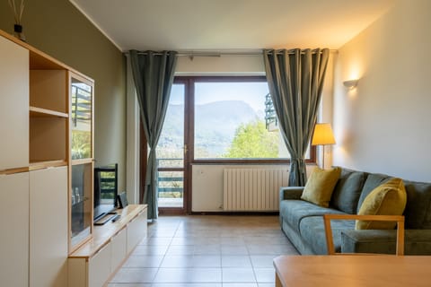 Apartment, 1 Bedroom, Balcony, Lake View | Living area | 30-inch TV with satellite channels