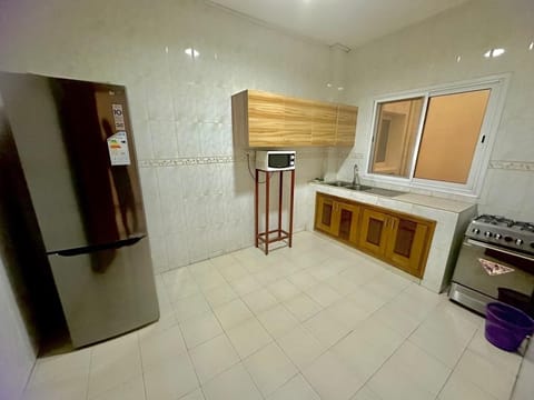 Comfort Apartment | Private kitchen | Full-size fridge, cleaning supplies