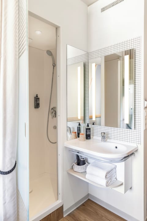 Shower, eco-friendly toiletries, hair dryer, towels