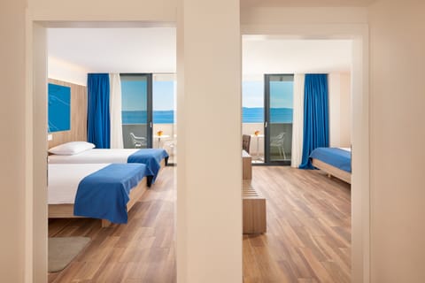 Deluxe Family Room, Balcony, Sea View | Premium bedding, minibar, in-room safe, desk