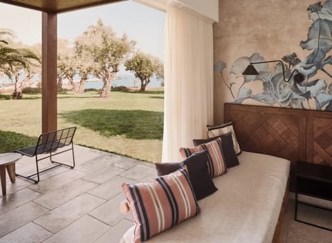 Bungalow (Beach Front) | Minibar, in-room safe, individually decorated, desk