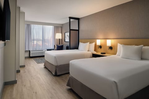 Premium bedding, desk, laptop workspace, blackout drapes