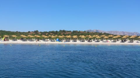 Private beach, white sand, sun loungers, beach umbrellas