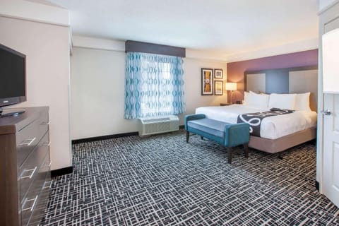 Premium bedding, desk, laptop workspace, blackout drapes