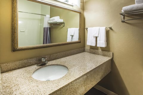 Premium bedding, desk, laptop workspace, blackout drapes