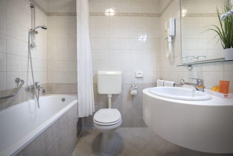 Bathtub, hair dryer, towels, soap