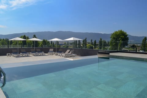Seasonal outdoor pool, open 9 AM to 8 PM, sun loungers