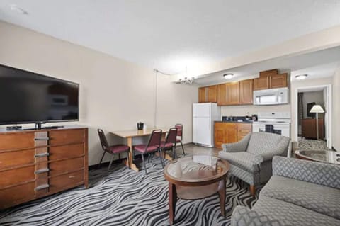 Suite, 1 Queen Bed, Kitchen | Living area | 50-inch LED TV with cable channels, TV