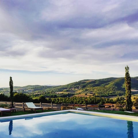 Seasonal outdoor pool, an infinity pool, pool umbrellas, sun loungers