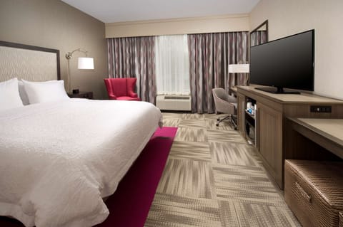 Premium bedding, desk, laptop workspace, blackout drapes