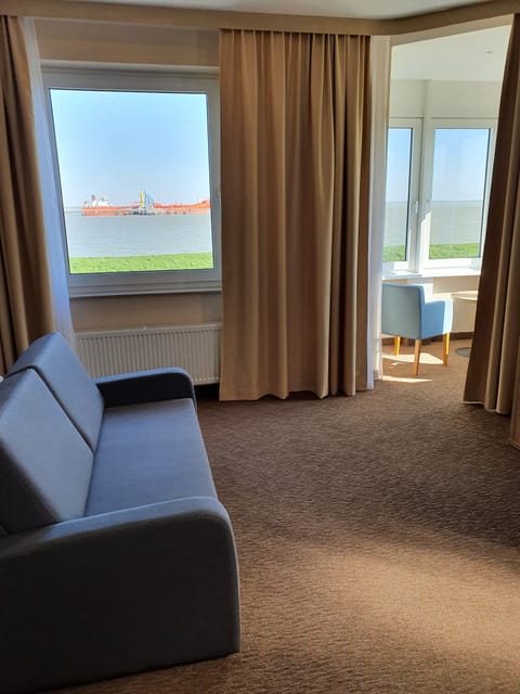 Junior Studio Suite, 1 Queen Bed, Non Smoking, Sea View | Living area | Tablet, books