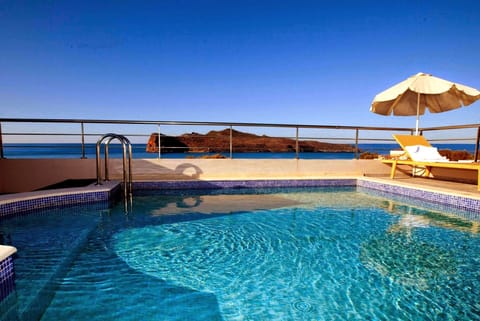 Seasonal outdoor pool, an infinity pool, pool umbrellas, sun loungers