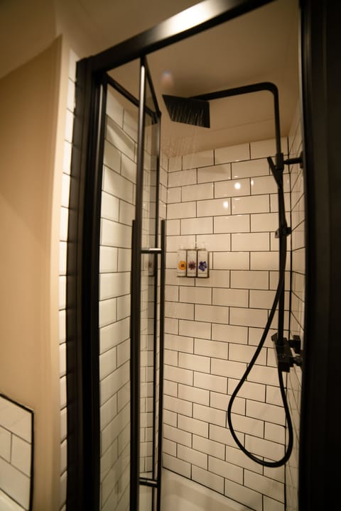 Shower, designer toiletries, hair dryer, towels