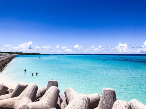 Beach nearby, white sand, beach umbrellas, beach towels
