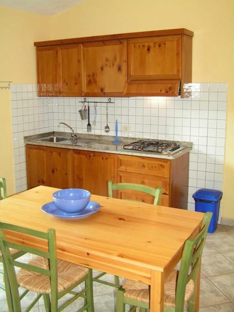 Full-size fridge, stovetop, coffee/tea maker, cookware/dishes/utensils